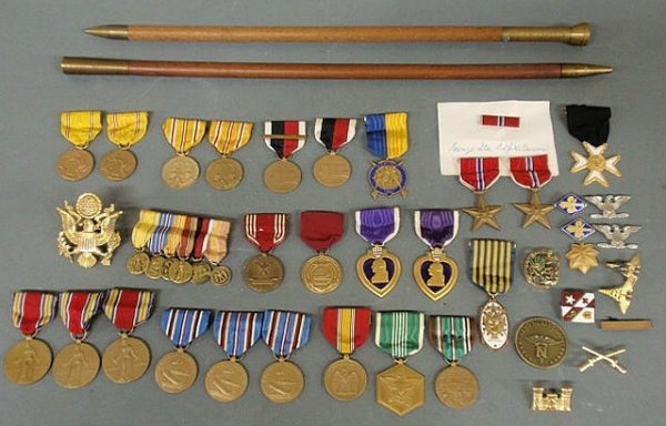 Collection of World War II medals and emblems from: Collection of World War II medals and emblems from Col. J.M. Cameron and two swagger sticks. Two Bronze Stars- one is inscribed “James M. Cameron”, two Purple Hearts- one is inscribed “James M. 