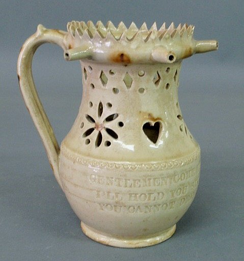 English pottery puzzle jug, 19th c., with verse "G: English pottery puzzle jug, 19th c., with verse "Gentlemen, come try your skill…". 7"h.x7"w.