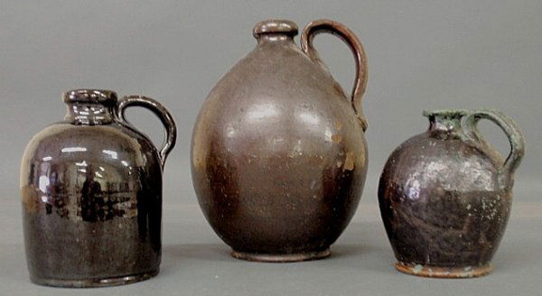 Three redware jugs, 19th c., 10"h., 7"h. & 6.25"h.: Three redware jugs, 19th c., 10"h., 7"h. & 6.25"h.