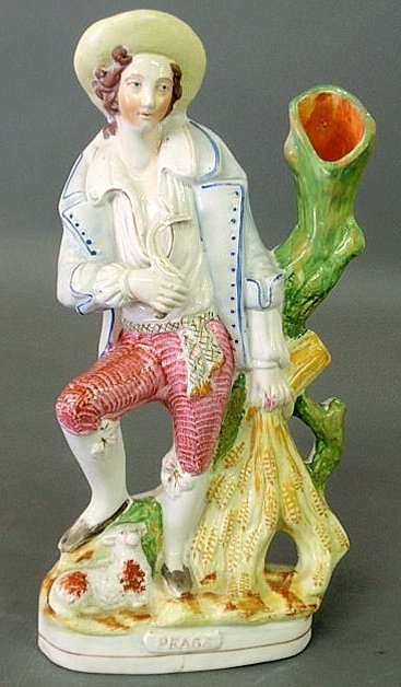 Staffordshire figural group spill vase of a farmer: Staffordshire figural group spill vase of a farmer with a sheaf of wheat titled "Peage". 14"h.x7.5"w.