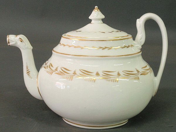 Philadelphia Tucker porcelain teapot with gilt spr: Philadelphia Tucker porcelain teapot with gilt sprig decoration and bird-head spout. 6.5"h.x9"w.