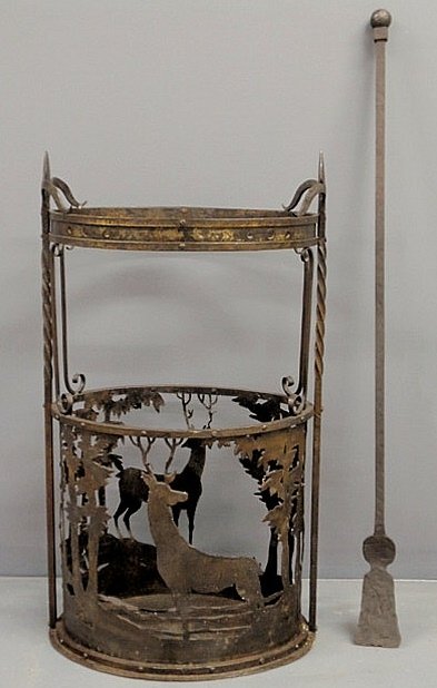 Oval wrought iron fireplace tool holder and tool, : Oval wrought iron fireplace tool holder and tool, early 20th c., in the manner of Samuel Yellin. 34.5”h.x19.5”w.x14”d.