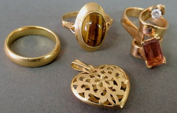 Two 14k yellow gold rings, 14k heart shaped locket: Two 14k yellow gold rings, 14k heart shaped locket, 18k gold wedding band- total 18.6 grams.