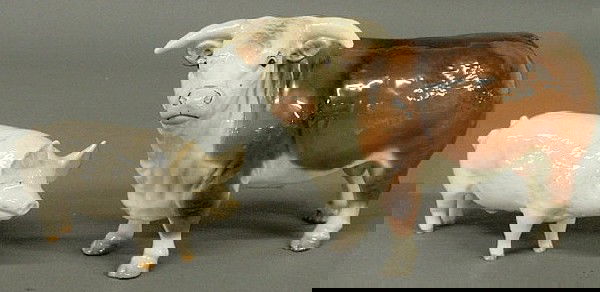 Beswick porcelain white hog 3"h.x7'l. and an unsig: Beswick porcelain white hog 3"h.x7'l. and an unsigned porcelain bull 5.25"h.x8"l.
