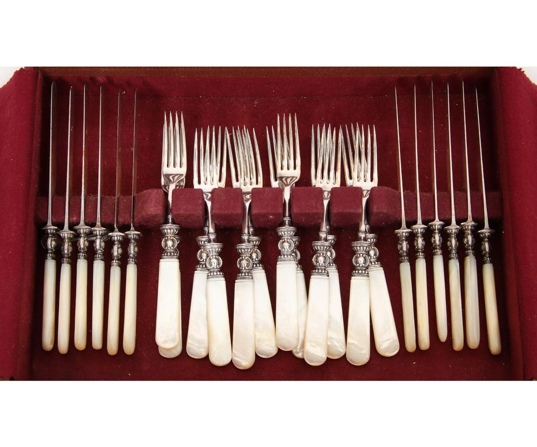 SET OF TWELVE STERLING SILVER: Set of twelve sterling silver banded knives and forks with mother-of-pearl handles. Fork: 7.5" Knife: 8.5 Box: 10.5" x 15"