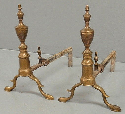Pair of Federal brass andirons, c.1790, with urn f: Pair of Federal brass andirons, c.1790, with urn form finials and log stops and spurred arched legs. 16"h.x10.5"w.x17.5"d.