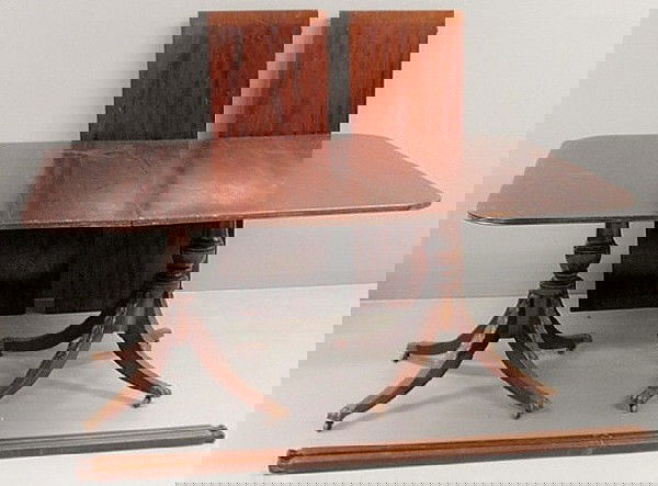 Duncan Phyfe style banquet table with a double ped: Duncan Phyfe style banquet table with a double pedestal base and two extra leaves. 29"h.x104.5"l.x47"w.