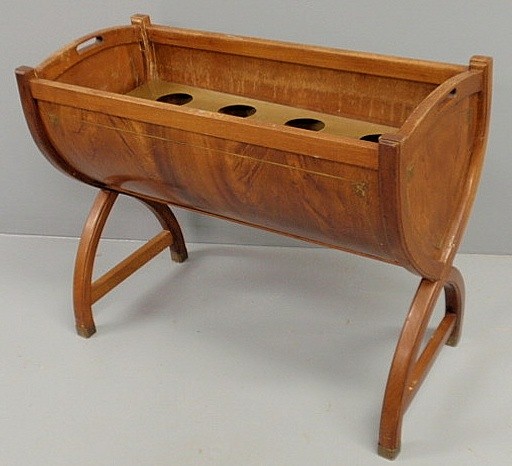 English Regency mahogany cradle, 19th c., the bras: English Regency mahogany cradle, 19th c., the brass interior retrofitted to hold wine bottles. 28"h.x36"l.x16"w.