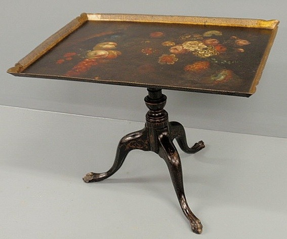 Tole decorated tray-top table with a wood base wit: Tole decorated tray-top table with a wood base with turned shaft and snake feet. 23"h., top 30.25"x21.75
