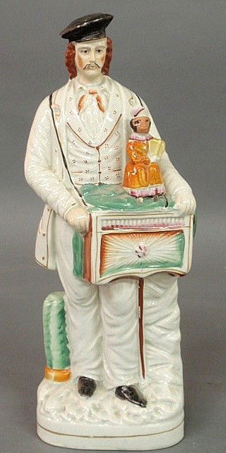 Staffordshire figure of an organ grinder and his m: Staffordshire figure of an organ grinder and his monkey, 19th c. 15"h.