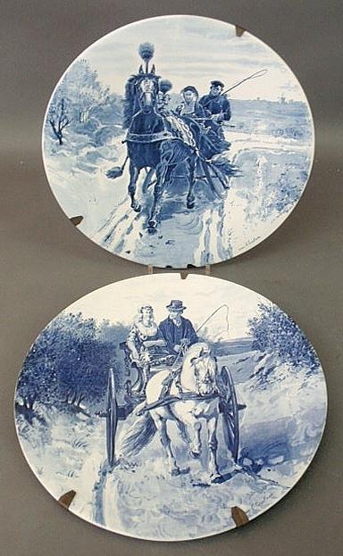 Pair of blue and white Delft chargers, artist sign: Pair of blue and white Delft chargers, artist signed "O. Erelman (?)", one of a horse drawn sleigh and the other of a horse drawn open buggy. 17.25"dia.