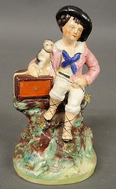 Staffordshire figure of an organ grinder and his m: Staffordshire figure of an organ grinder and his monkey, 19th c. 7"h.