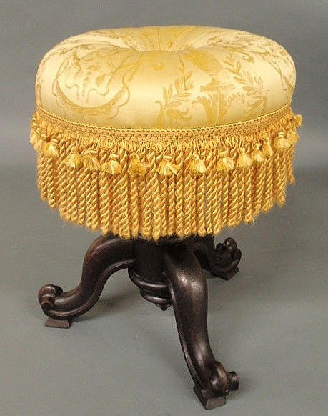 Victorian carved walnut organ/piano stool with yel: Victorian carved walnut organ/piano stool with yellow upholstered and fringed top. 20"h., 15"dia.