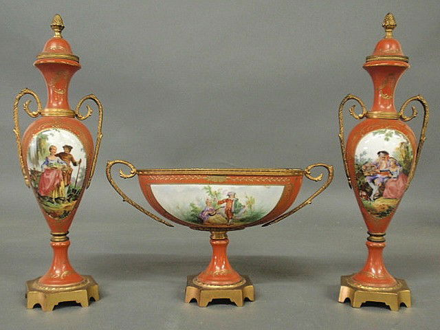 Three-piece French porcelain garniture set, late 1: Three-piece French porcelain garniture set, late 19th c., each with painted panels and gilt mounts, vases 14.5"h., bowl 7"h.x12"w.