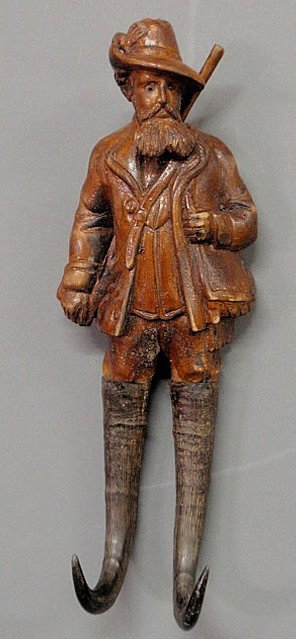Black Forest carved huntsman coat hook with goat h: Black Forest carved huntsman coat hook with goat horn feet, late 19th century. 13.5"h.