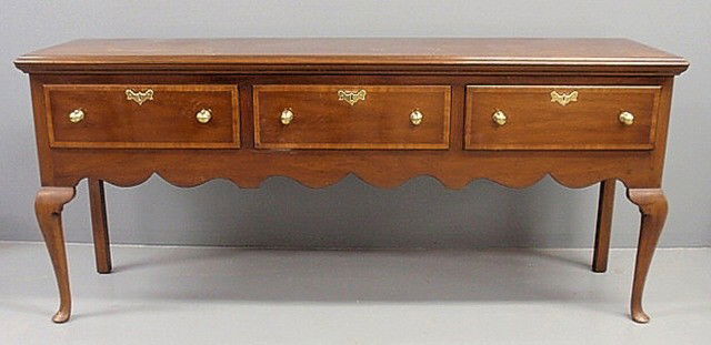 Kittinger mahogany huntboard, Williamsburg Queen A: Kittinger mahogany huntboard, Williamsburg Queen Anne style, with a molded top, scalloped apron and pad feet, pattern #CW148-CW2. 33.5"h.x77"l.x21.5"d.