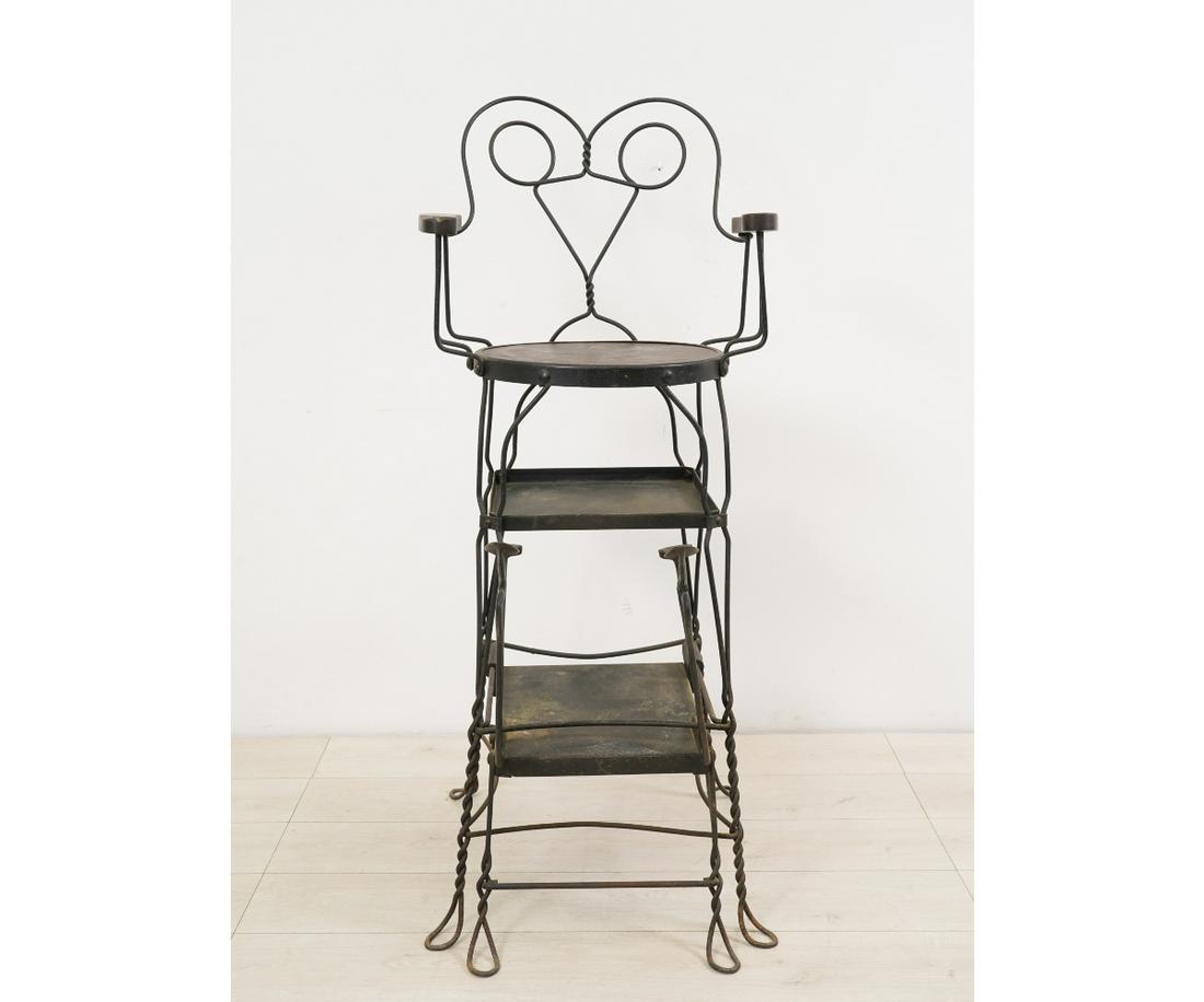 IRON AND OAK BARBER CHAIR: Iron and oak barber chair, circa 1900, with adjustable foot rests. 52"h x 22.25"w x 26"d / seat height = 36"