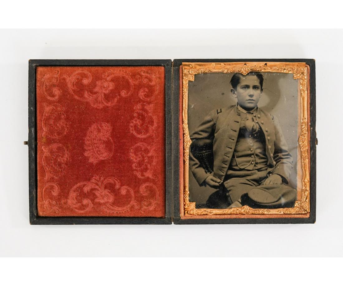 CIVIL WAR CONFEDERATE OFFICER TINTYPE: Tintype of U.S. Confederate officer seated with his keppi, mounted in a velvet-lined period case. Case: 3.75" x 3"