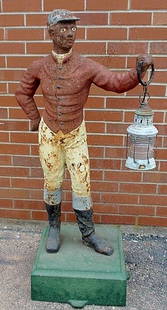 Cast iron jockey, 19th c., with paint decoration: Cast iron jockey, 19th c., with paint decoration and green painted base. 49"h., base 16"x16