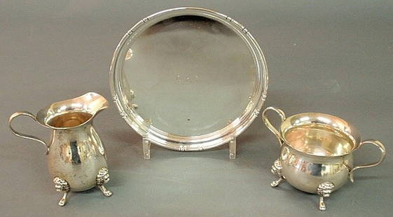 Round sterling silver tray 7"dia., creamer 4"h. a: Round sterling silver tray 7"dia., creamer 4"h. and sugar bowl.