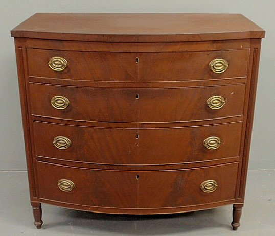 Sheraton mahogany bow-front chest of drawers, c.1: Sheraton mahogany bow-front chest of drawers, c.1800, with turned legs. 39.5"h.x41.5"w.x23"d.