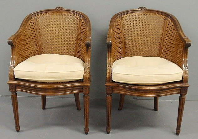 Pair of French cane-back bergères with fluted rou: Pair of French cane-back bergères with fluted round legs. 35"h.x23"w.x24"d., seats 17.5"h.