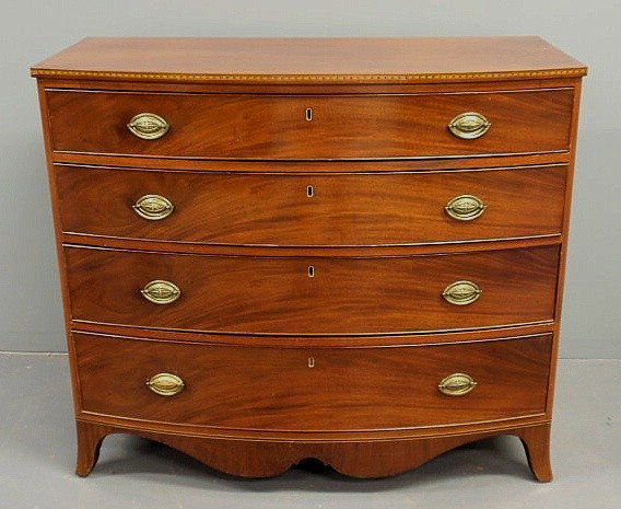Hepplewhite inlaid mahogany bow-front chest of dr: Hepplewhite inlaid mahogany bow-front chest of drawers, c.1790, with a scalloped skirt and French feet. 37"h.x43"w.x21.75"d.