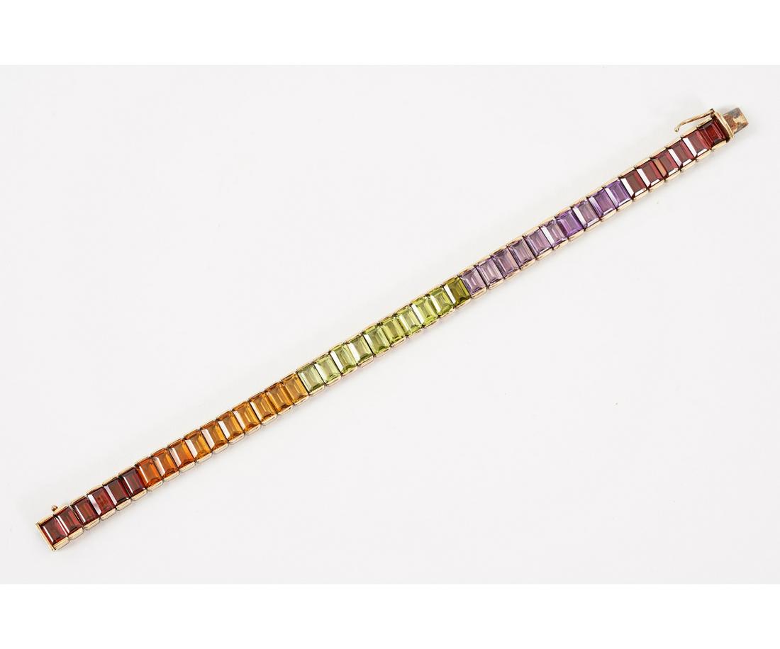 RAINBOW STONE BRACELET: 14k gold emerald cut semi-precious quartz bracelet in varying shades of the rainbow.Weight: 15.4dwtDimensions: 7.25"l x .25"w