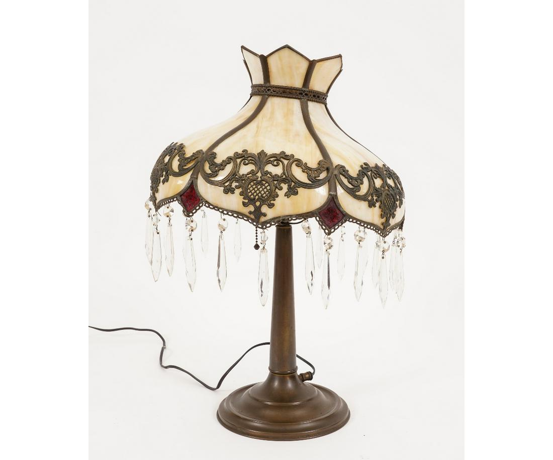 ORNATE SLAG GLASS LAMP: Ornate slag glass lamp with brass base, circa 1920, numbered on the bottom. 23"h x 15"dia
