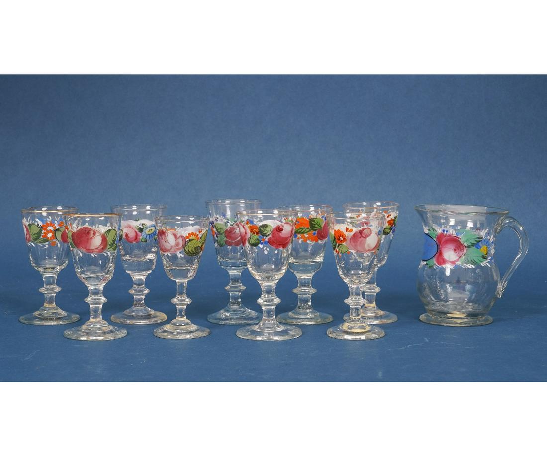 ENAMEL PAINTED WINE GLASSES: Nine enamel painted wine glasses, gilt rimmed, 19th c.; together with a pitcher "Forget Me Not". Glasses: 5.25"h x 2.25"dia Provenance: Sotheby's Parke Bernet