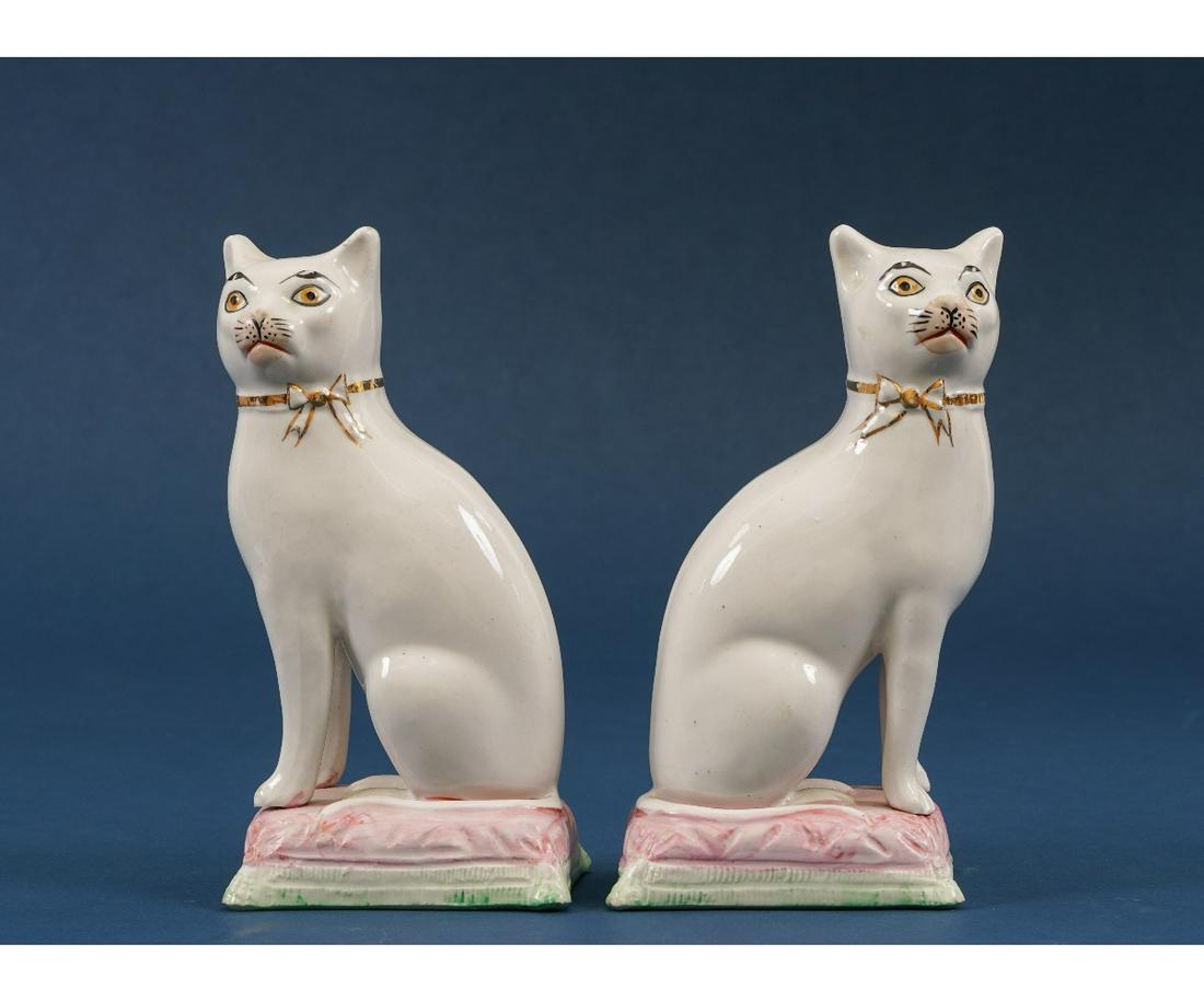 STAFFORDSHIRE SEATED CATS: Pair of Staffordshire seated cats on pillows, circa 1860. 7"h x 3.75"w x 3.75"d