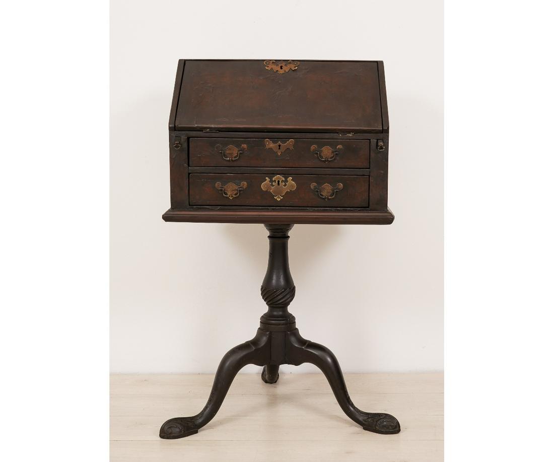 DIMINUTIVE QUEEN ANNE DESK: Diminutive Queen Anne walnut slant lid desk, veneered, 18th c., resting on a turned shaft and three down swept legs. 39"h x 22"w x 15.25"d