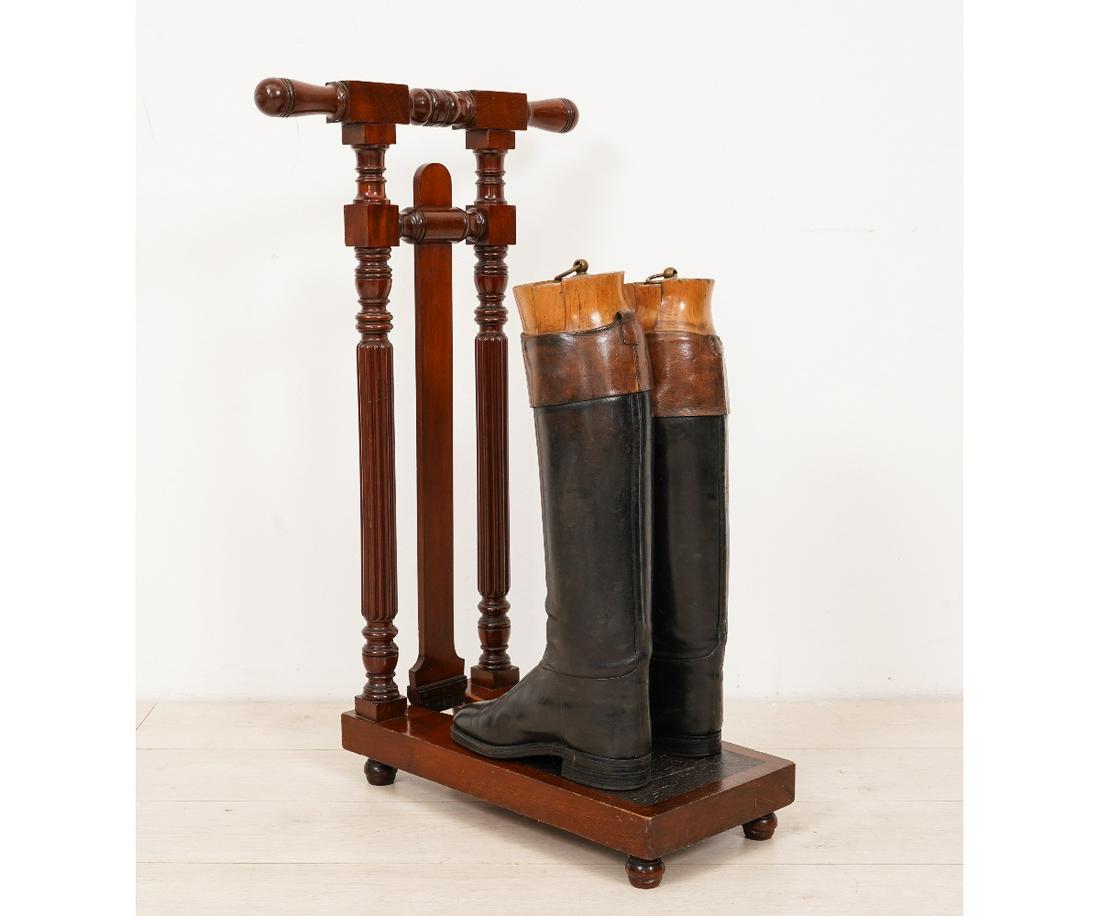 ENGLISH BOOT JACK: English mahogany boot jack with "Peal & Co." label; together with two similar riding boots with inserts. Jacks: 33.5"h x 20"w x 20"d