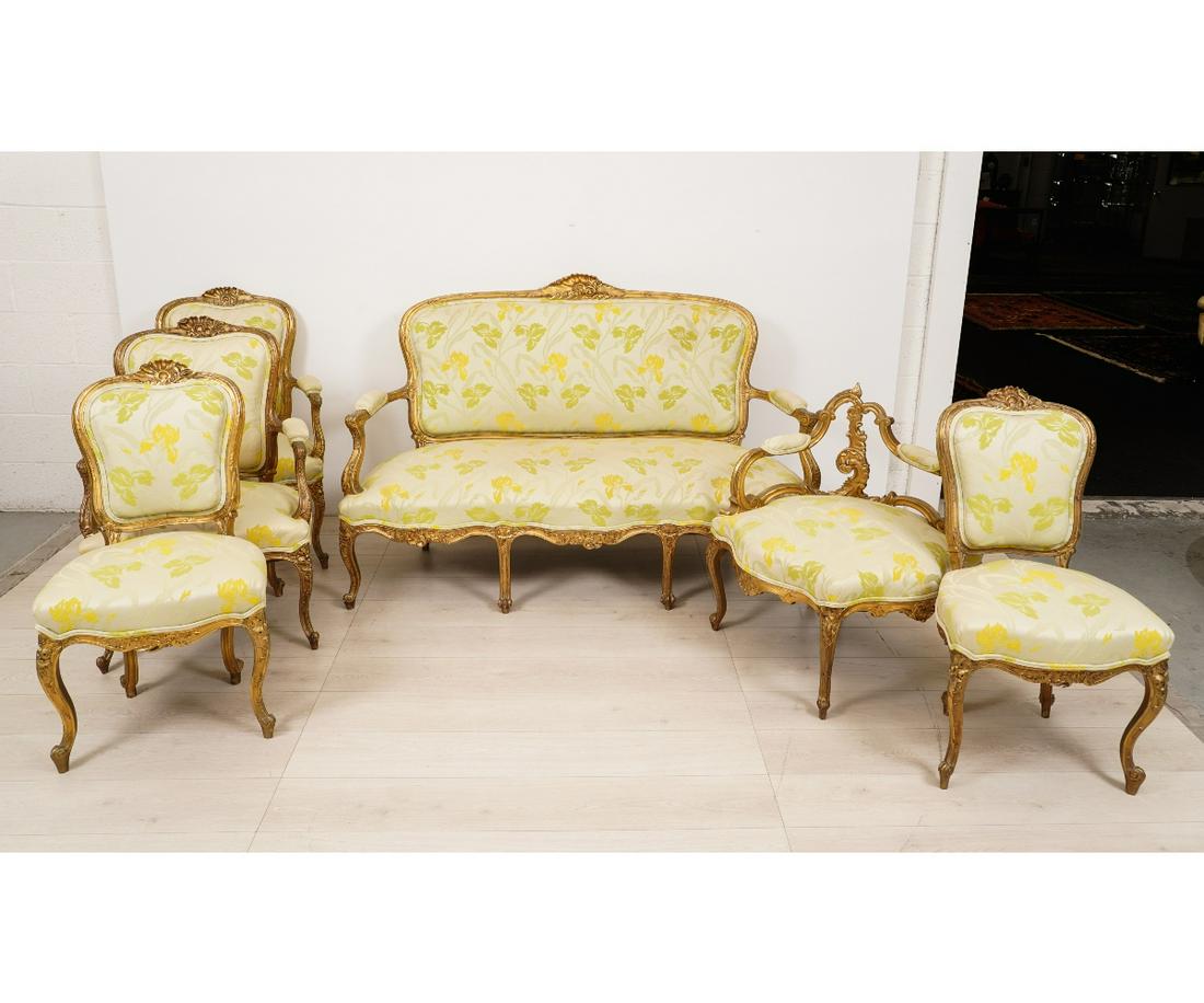LOUIS XVI STYLE CARVED SUITE: Louis XVI style carved suite to include a settee and five chairs, circa 1930. Settee: 41"h x 61"w x 26"d / 15" seat height Armchair: 37.5"h x 24"w x 21"d / 16" seat height