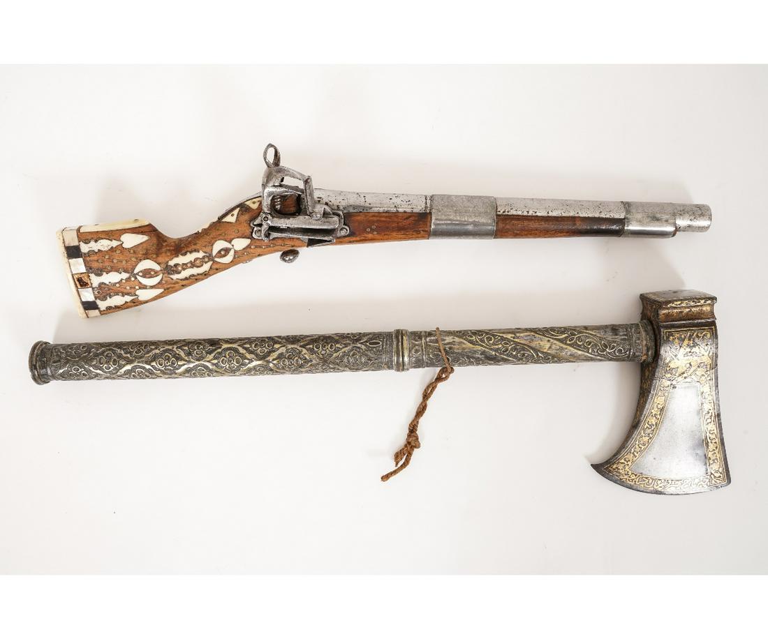PERSIAN FLINTLOCK PISTOL etc.: Persian flintlock pistol with bone inlay; together with a metal hatchet with brass inlays, both probably 19th c. Pistol: 16.25"l Hatchet: 18"l x 5.25"w