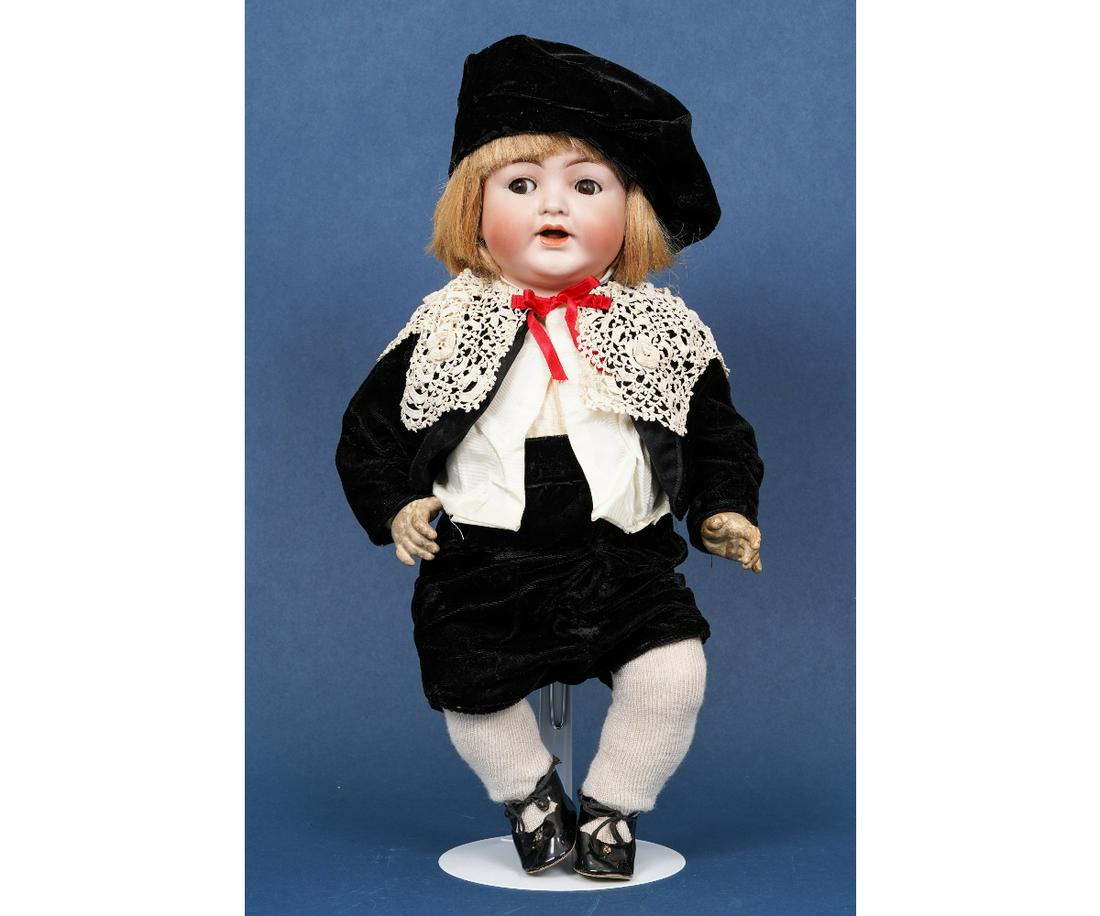 SIMON & HALBIG DOLL: German Simon & Halbig bisque head doll #126, little boy in a black velvet costume with lace collar. 19.5"h