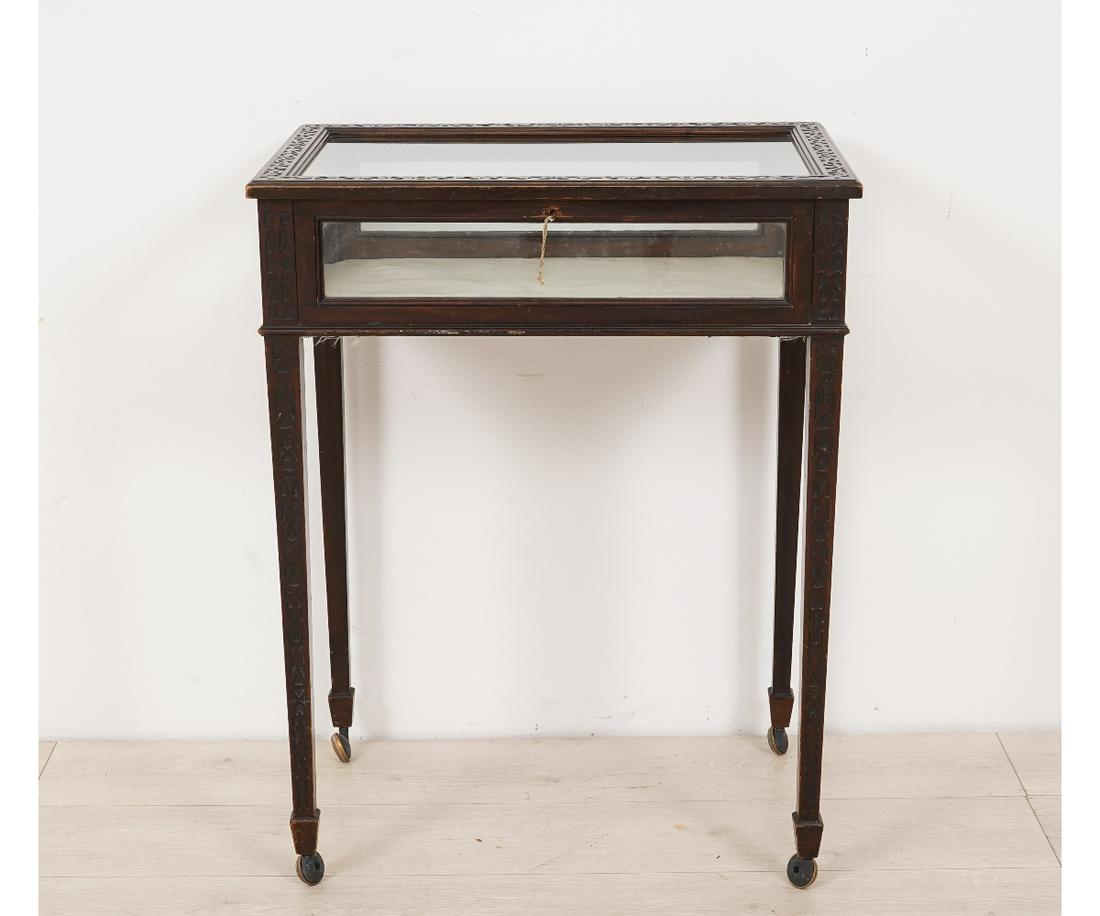 CURIO CABINET: Chippendale style mahogany curio cabinet, 20th c., with metal casters of a later date. 30.5"h x 24.25"w x 16"d