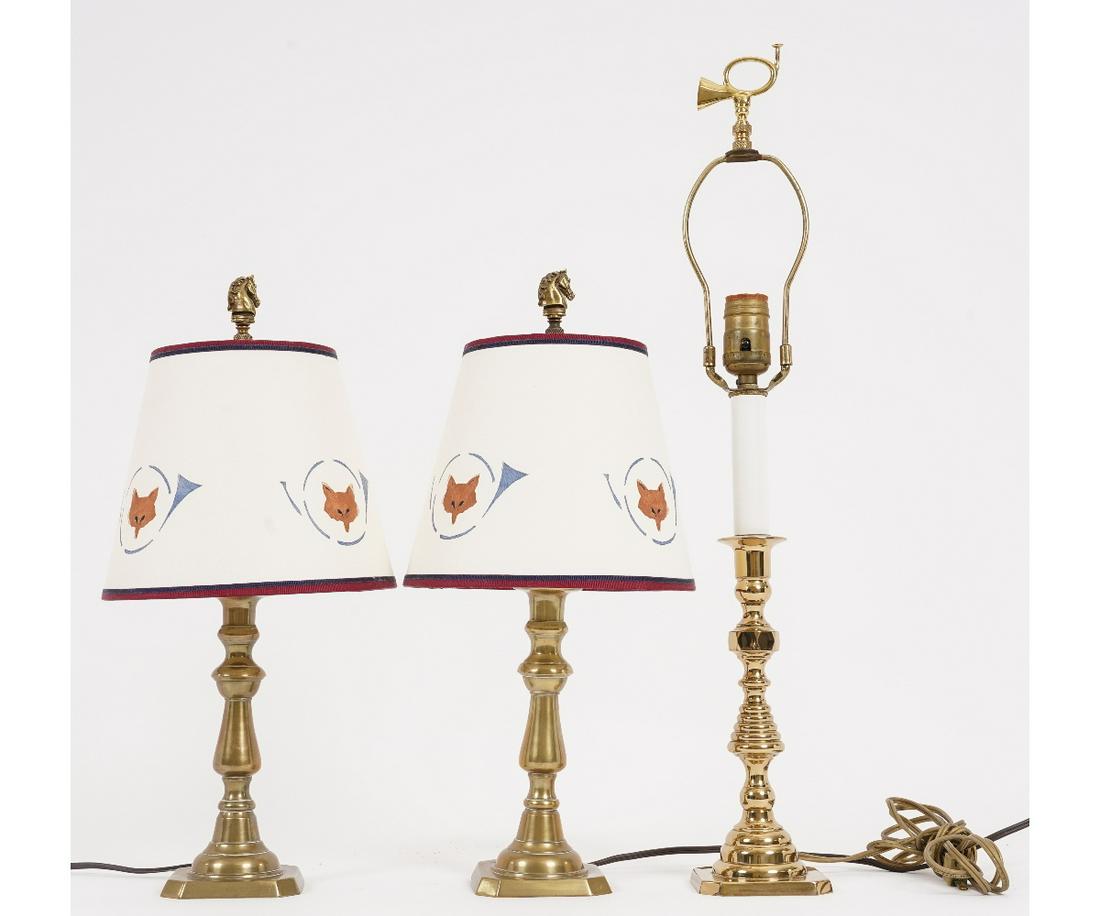 PAIR BRASS CANDLESTICK LAMPS: Pair of English Victorian brass candlesticks converted to electric lamps with painted shades and brass fox head finials, each 18"h; together with a single lamp.