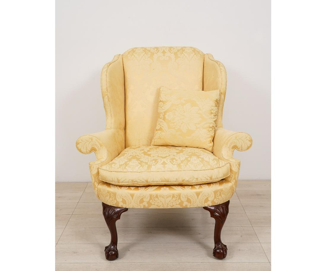 KINDEL CHIPPENDALE STYLE WING CHAIR: Kindel Chippendale style mahogany Winterthur Reproduction wing chair, with ball and claw feet and covered in yellow Scalamandre fabric. 44"h x 40"w x 30"d