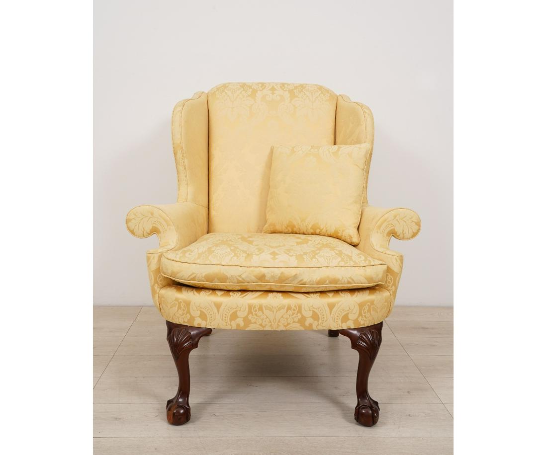 KINDEL CHIPPENDALE STYLE WING CHAIR: Kindel Chippendale style mahogany Winterthur Reproduction wing chair, with ball and claw feet and covered in yellow Scalamandre fabric. 44"h x 40"w x 30"d
