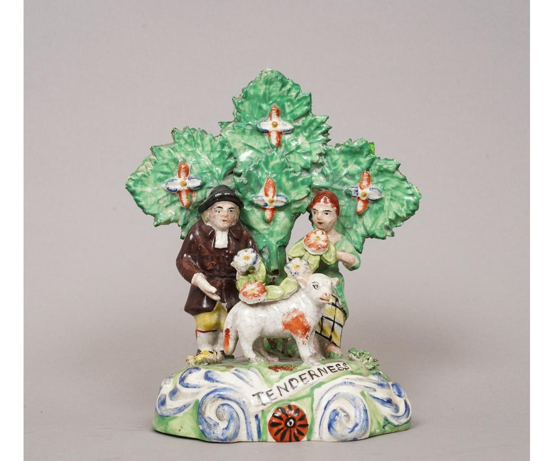 STAFFORDSHIRE FIGURE: Staffordshire figure titled "Tenderness" depicting a male and female figure decorating sheep with flowers, circa 1825, marked Walton. 7"h x 5.75"