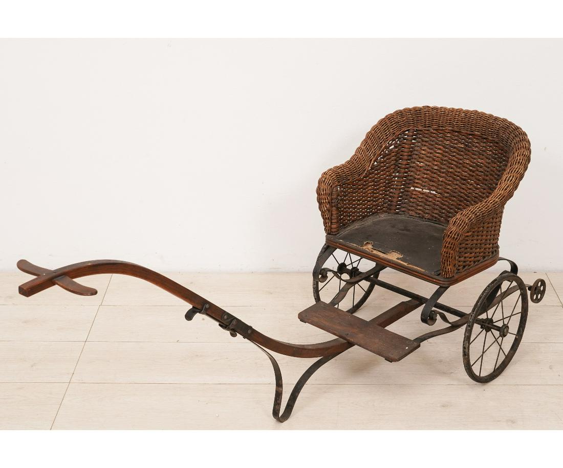 CHILD'S WICKER SULKY: Child's wicker sulky with leather seat, circa 1890. 21.5"h x 19"w x 60"l