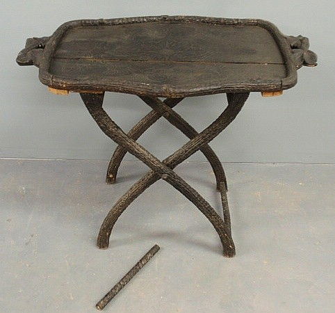 Black Forest carved tray-top table, late 19th c.,: Black Forest carved tray-top table, late 19th c., with leaf carved handles and bark-form legs. As found. 29.5"h., top 35"x22"