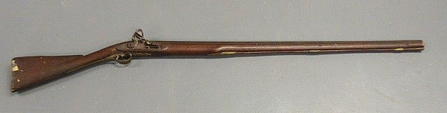 Flintlock musket, early 19th c., marked "Ketland: Flintlock musket, early 19th c., marked "Ketland & Co., London" with a brass trigger guard and back plate. 53"l.