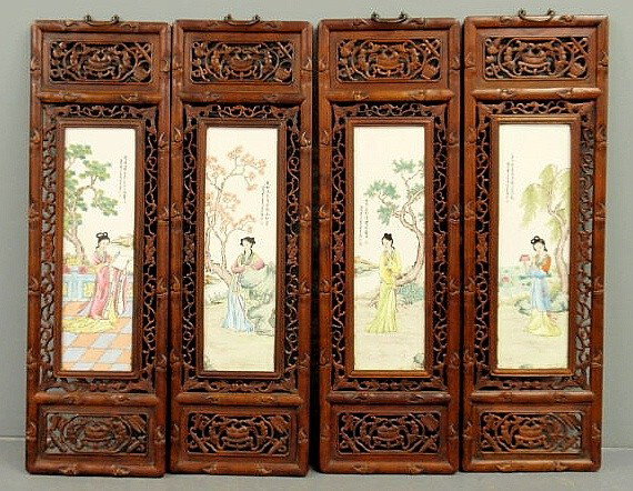 Four Asian carved exotic wood panels with painted