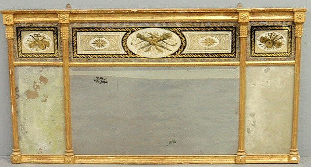 Rare gilt decorated three-part mirror, c.1800, wi: Rare gilt decorated three-part mirror, c.1800, with three original églomisé panels and four carved rosettes. 30"h.x57"w.