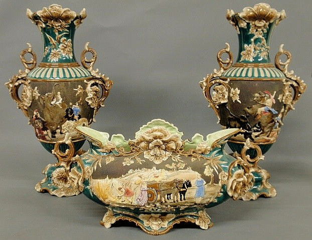 Colorful three-piece majolica garniture set, late: Colorful three-piece majolica garniture set, late 19th c., decorated with animals and Roman style figures. centerpiece bowl 10.5"h.x23"w., vases 23"h.x14"w.x8"d.