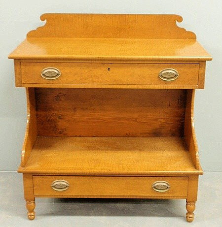Sheraton tiger maple side server with a carved ba: Sheraton tiger maple side server with a carved backsplash above a single drawer above an open shelf above a single drawer and turned feet. 39"h.x34.5"w.x15.5"d.
