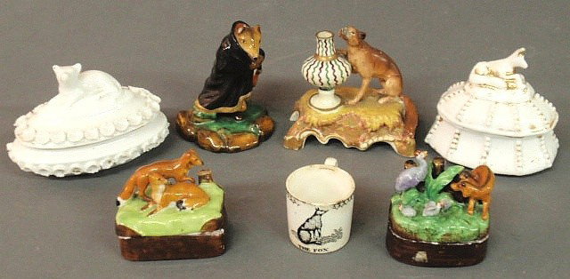 Four porcelain covered boxes with fox decorated l: Four porcelain covered boxes with fox decorated lids, English creamware mug with transfer decoration "The Fox", a porcelain fox dressed in a robe 4"h., and a porcelain fox with an urn, all 19th c.