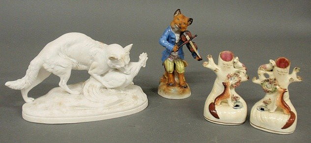 Parian ware figure of a fox with game, after a br: Parian ware figure of a fox with game, after a bronze by C. Moigniez 5"h.x8"w., German porcelain figure of a fox playing a fiddle 6.25"h., 19th c., and pair of Staffordshire porcelain quill holders, c
